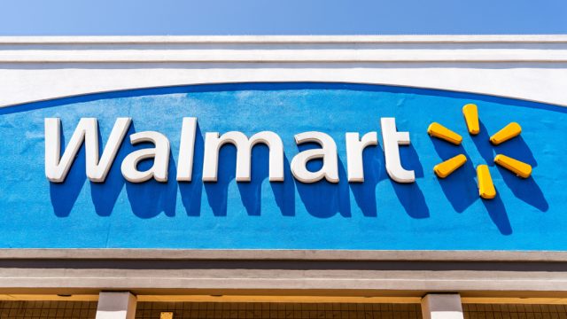 The exterior sign of a Walmart location with a blue background