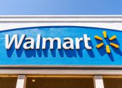 The exterior sign of a Walmart location with a blue background