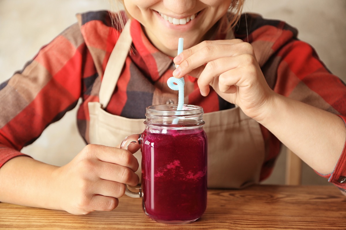 woman drinking beet juice smoothie