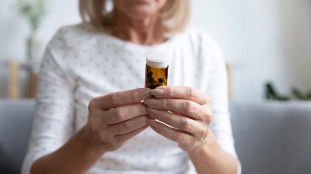 an older woman looking at medicine