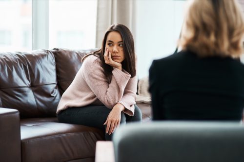 shot of a young woman having a therapeutic session with a psychologist