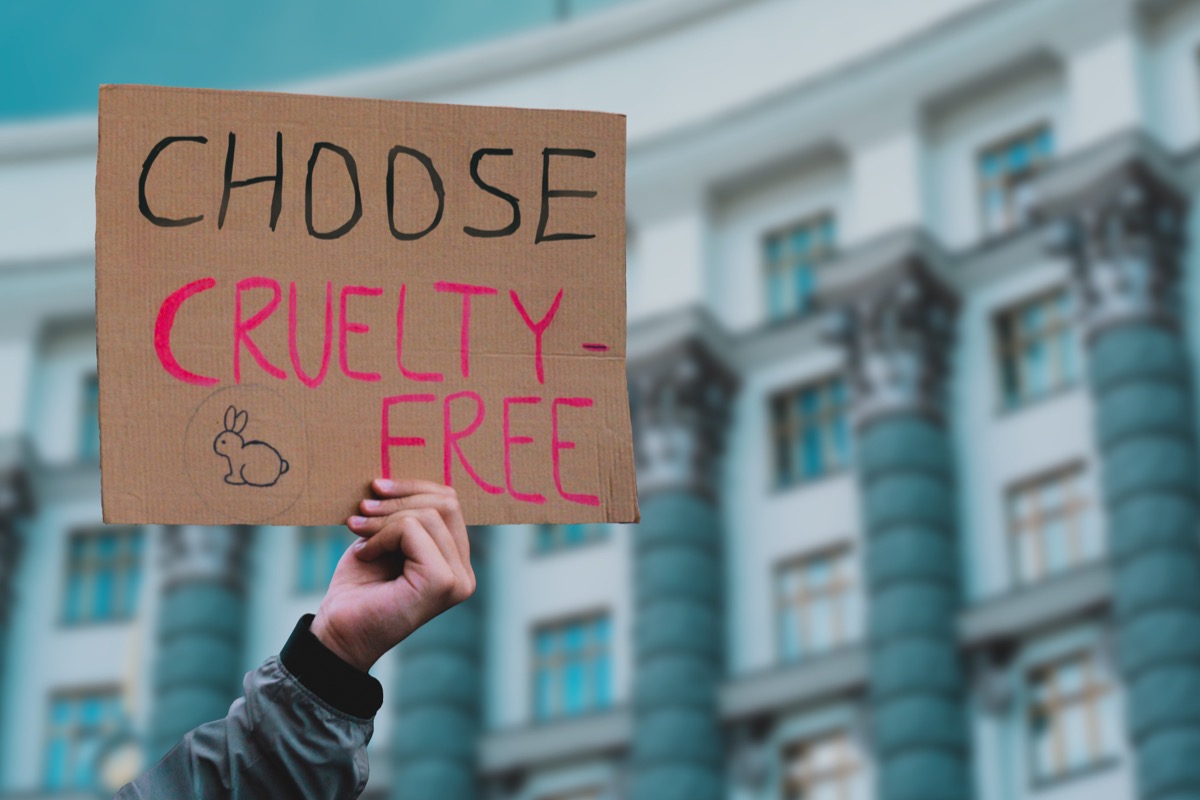 Animal activist holding "choose cruelty-free" sign