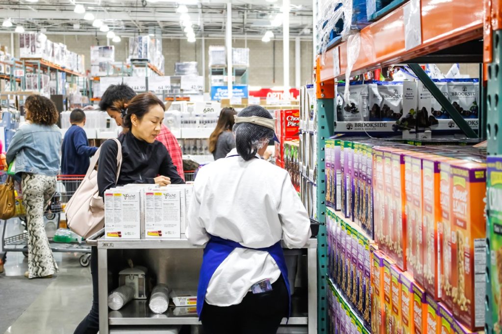 Tustin, California/United States - 02/08/2020: A view of the back of a female employee offering samples at a local Costco.