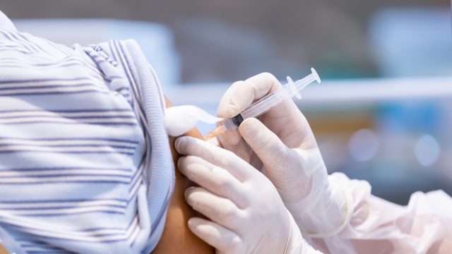 Closeup of covid-19 vaccine being injected into patient's arm