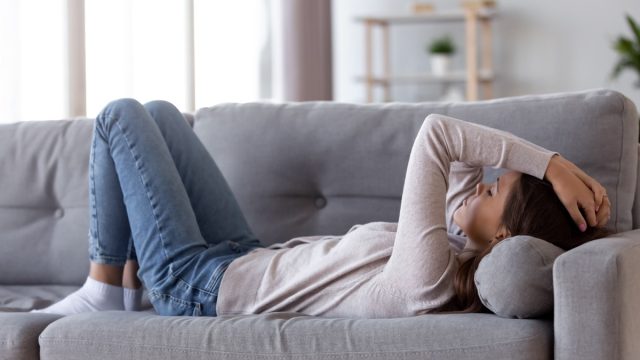 Woman with fatigue on couch