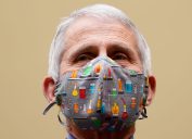 Dr. Anthony Fauci wearing a face mask with lab equipment depicted on it