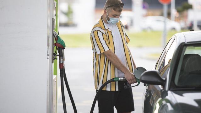 Young Adult Man With Protective Face Mask Refueling Car.