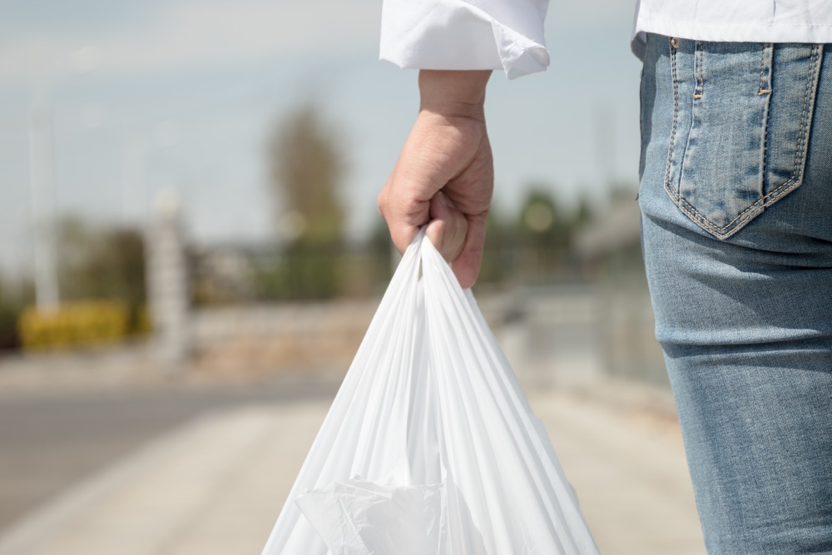 person holding plastic bag outside