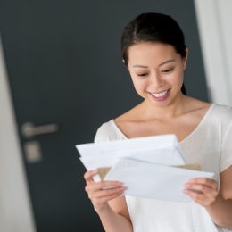 woman at home checking her mail and looking very happy - lifestyle concepts