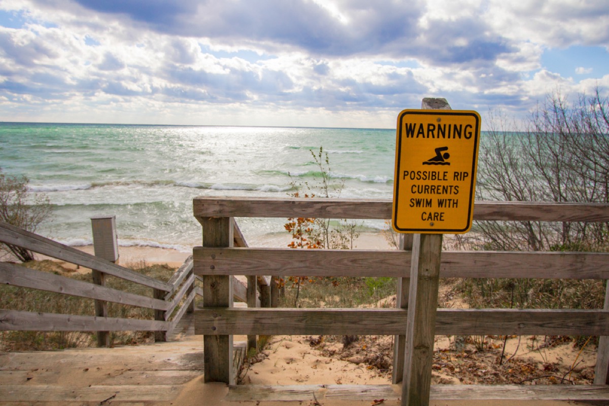 rip current warning sign near ocean