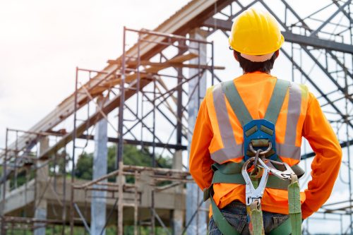 Construction worker in safety harness and hard hat