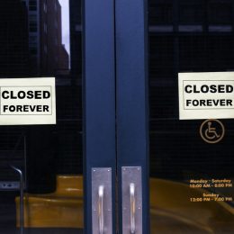 A store with "closed forever" signs hanging in the front doors