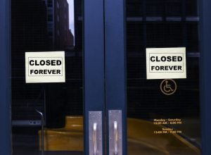 A store with "closed forever" signs hanging in the front doors