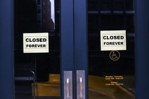 A store with "closed forever" signs hanging in the front doors