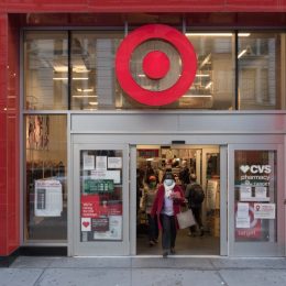 Manhattan, New York. November 20, 2020. A woman wearing a mask exits a Target store in Midtown.