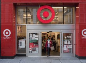 Manhattan, New York. November 20, 2020. A woman wearing a mask exits a Target store in Midtown.