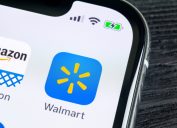 Walmart application icon on Apple iPhone X screen close-up.