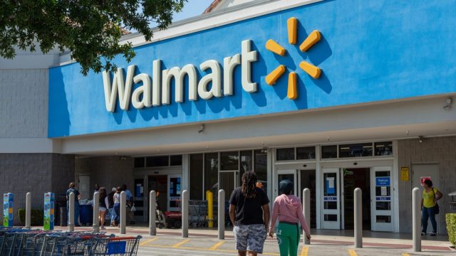 Miami, FL, USA - March 26, 2020: People going in a Walmart store on sunny day. Walmart is the world's third largest public corporation that runs chains of department stores. Quarantine due Coronavirus