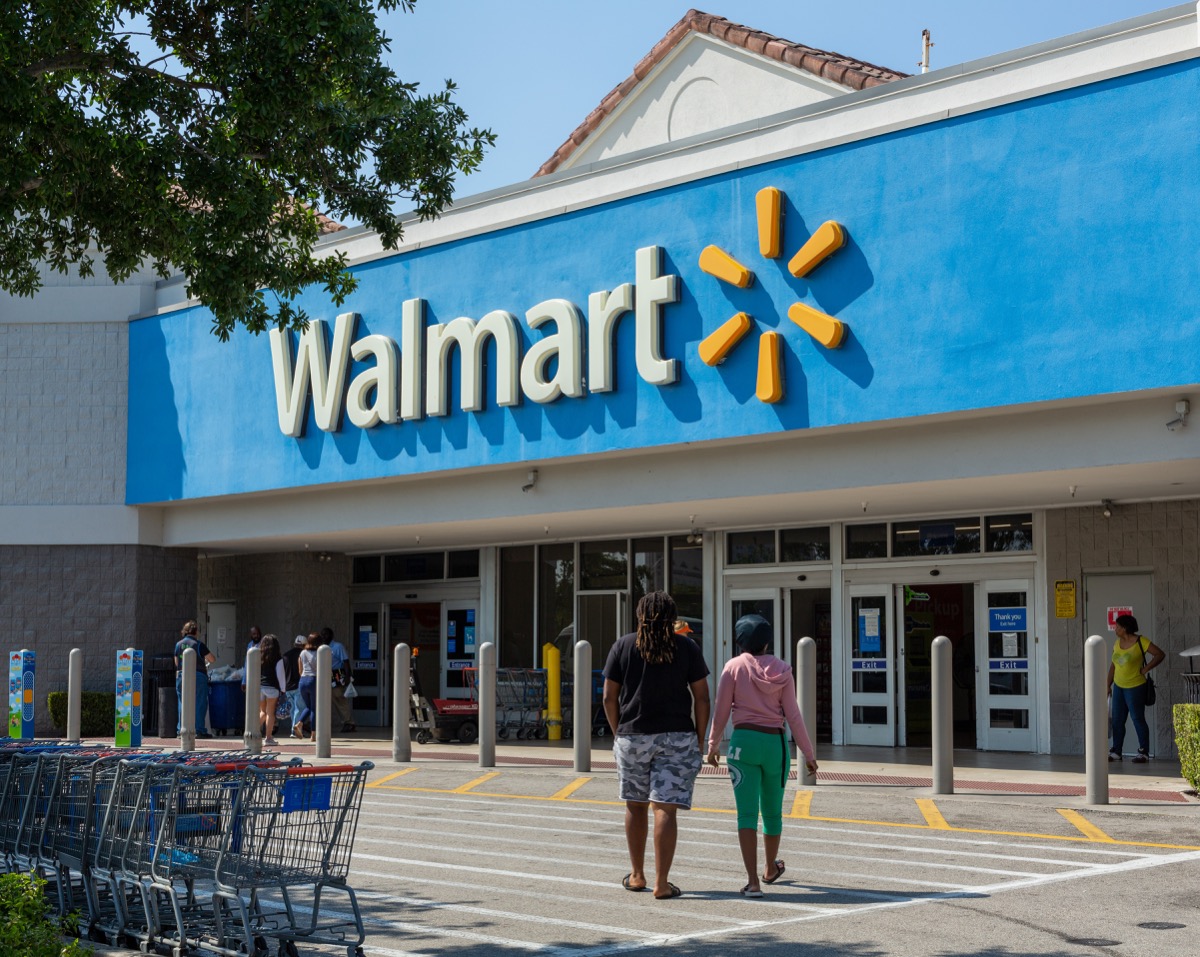 Miami, FL, USA - March 26, 2020: People going in a Walmart store on sunny day. Walmart is the world's third largest public corporation that runs chains of department stores. Quarantine due Coronavirus