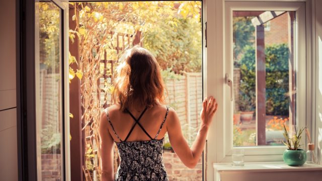 woman looking out door into garden