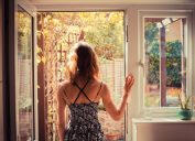 woman looking out door into garden