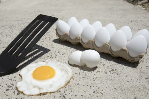 Frying egg on sidewalk