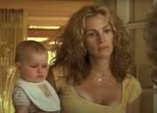 Julia Roberts holding a baby in "Erin Brockovich"