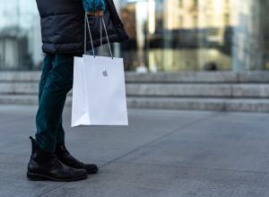 Shopper walking with an Apple store bag