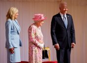 US President Joe Biden (R) and US First Lady Jill Biden (L) share a joke with with Britain's Queen Elizabeth II (C) before watching the military march past at Windsor Castle in Windsor, west of London, on June 13, 2021.