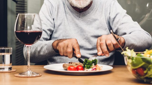 Older man eating dinner