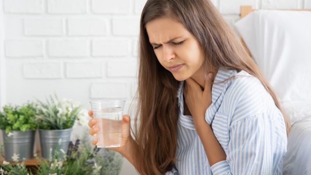 choking woman while drinking water;