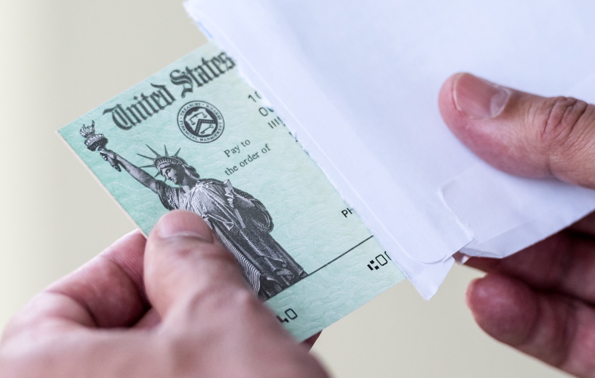 Man hands holding a US Government Treasury check