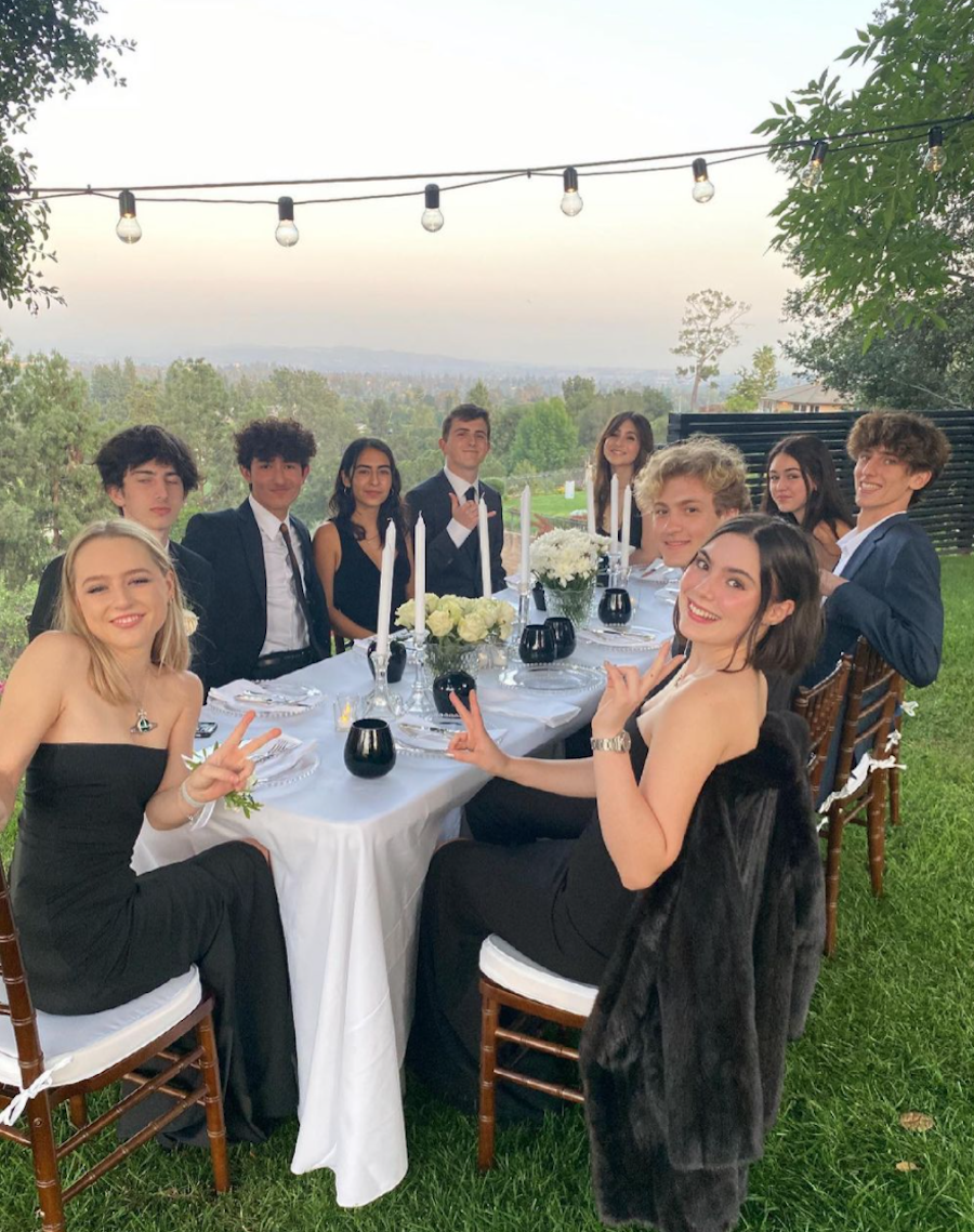 Lola Ray Facinelli and friends sitting around a table on prom night