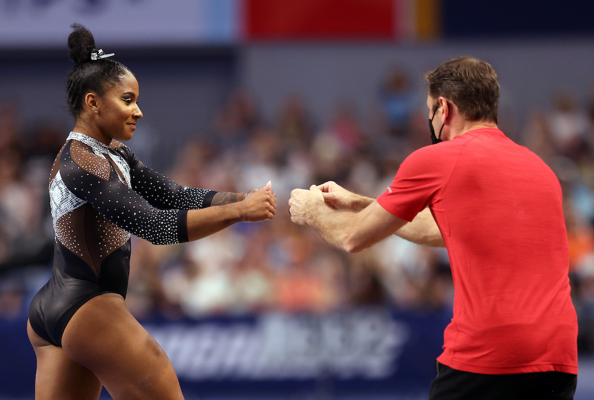 Jordan Chiles is congratulated by coach after competing on the vault during the Senior Women's competition of the U.S. Gymnastics Championships at Dickies Arena on June 06, 2021 in Fort Worth, Texas