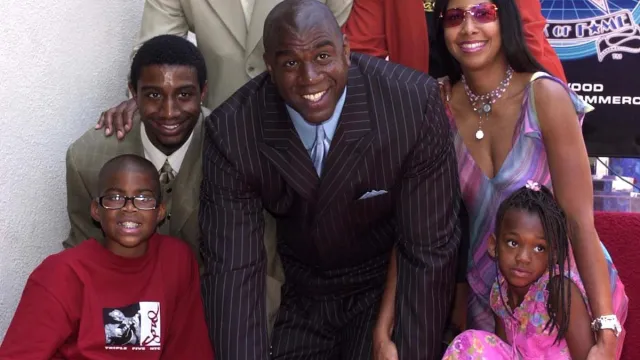 Former Los Angeles Lakers' basketball star Earvin "Magic" Johnson (C) poses with his family (clockwise from bottom L): son Earvin Jr., son Andre, wife Cookie, daughter Elisa, on his newly unveiled star on the Hollywood Walk of Fame in Los Angeles, 21 June 2001