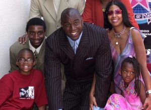 Former Los Angeles Lakers' basketball star Earvin "Magic" Johnson (C) poses with his family (clockwise from bottom L): son Earvin Jr., son Andre, wife Cookie, daughter Elisa, on his newly unveiled star on the Hollywood Walk of Fame in Los Angeles, 21 June 2001