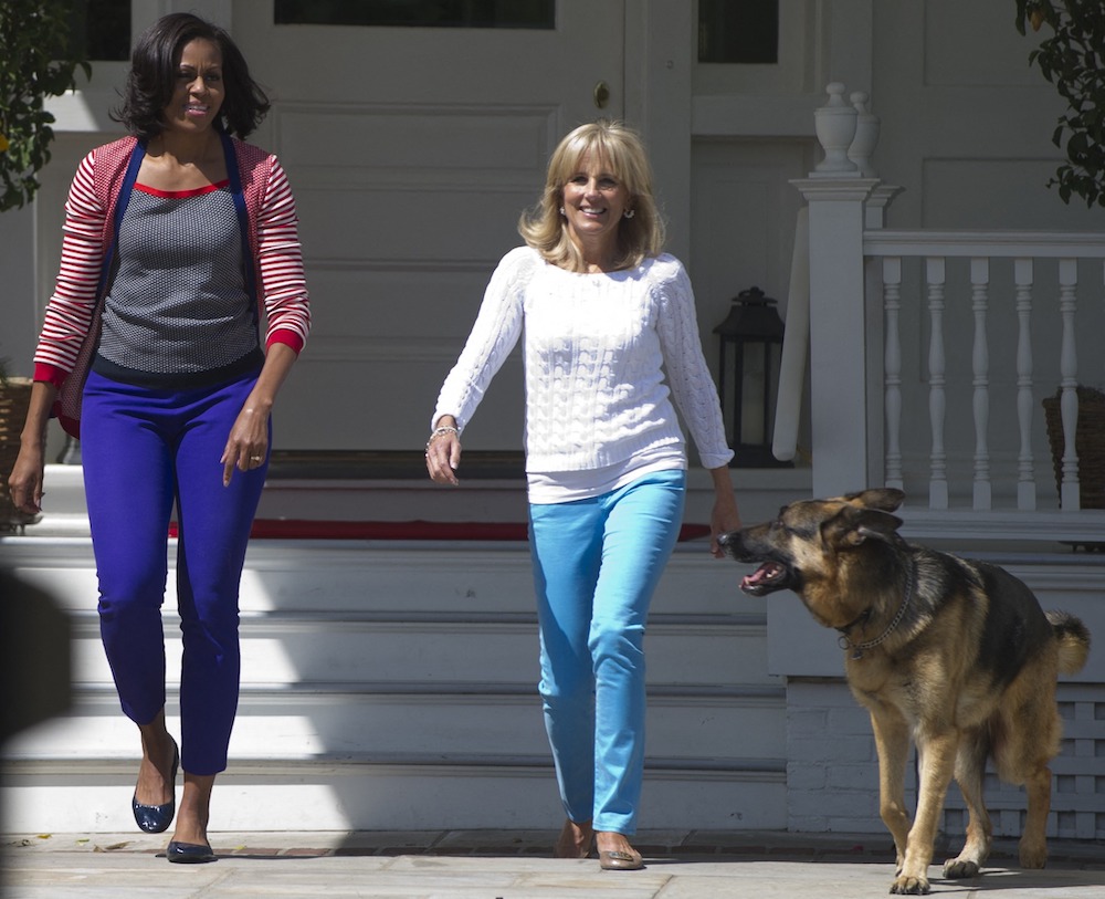 Then US First Lady Michelle Obama and Jill Biden, wife of then US Vice President Joe Biden, and their dog Champ, arrive to help assemble Mother's Day packages that deployed US troops have requested to be sent to their mothers and wives at home as part of a Joining Forces service event with spouses of members of Congress at the Naval Observatory in Washington, DC, May 10, 2012. 