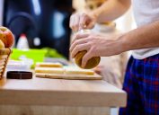 Close-up of unrecognizable father making peanut butter sandwiches for his 6 year old son