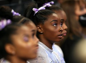 Simone Biles watches the competition prior to competing on the uneven bars during the Senior Women's competition of the 2021 U.S. Gymnastics Championships at Dickies Arena on June 04, 2021 in Fort Worth, Texas.
