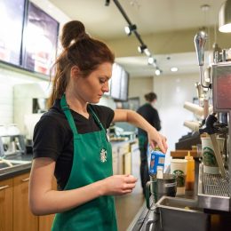 SAINT PETERSBURG, RUSSIA - MARCH 12, 2016: worker at Starbucks Cafe. Starbucks Corporation is an American global coffee company and coffeehouse chain based in Seattle, Washington