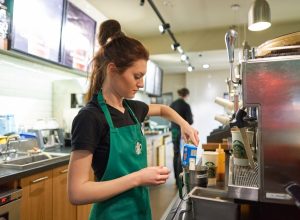 SAINT PETERSBURG, RUSSIA - MARCH 12, 2016: worker at Starbucks Cafe. Starbucks Corporation is an American global coffee company and coffeehouse chain based in Seattle, Washington