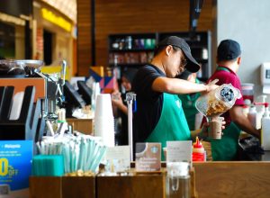 SEREMBAN,MALAYSIA - SEPTEMBER 18, 201T: Worker at Starbucks Cafe preparing coffee for customers.Starbucks is an American global coffee company and coffeehouse chain based in Seattle, Washington