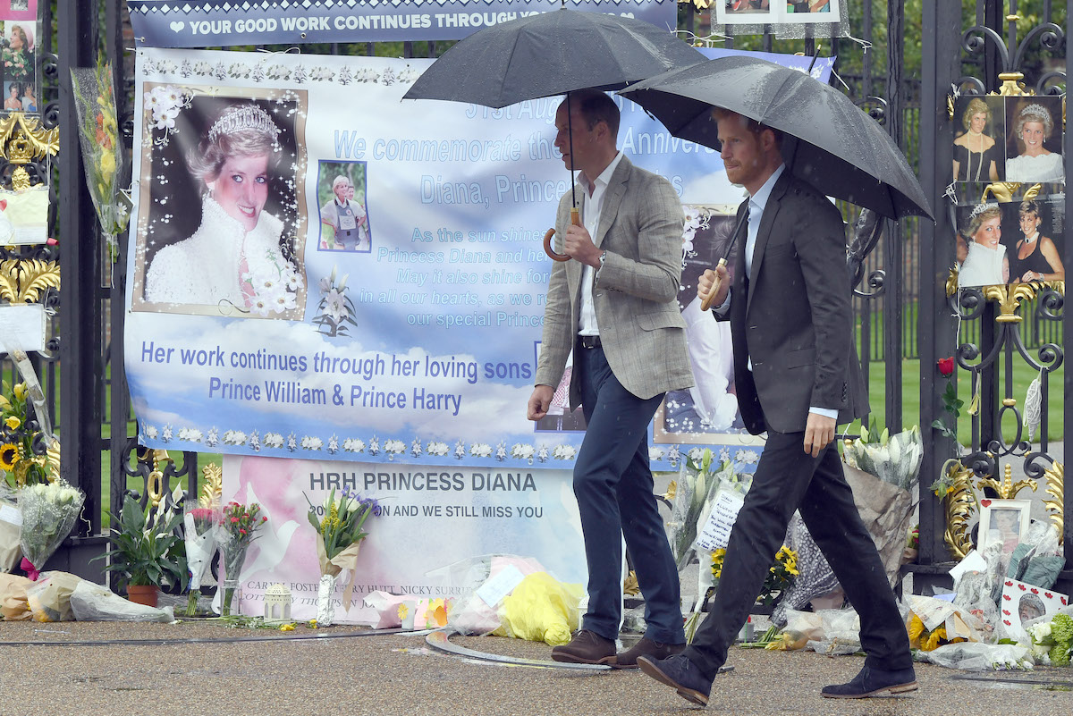 Prince William and Prince Harry view tributes to their mother Princess Diana following a visit to The White Garden in Kensington Palace dedicated in the memory of Princess Diana on August 30, 2017 in London, England.