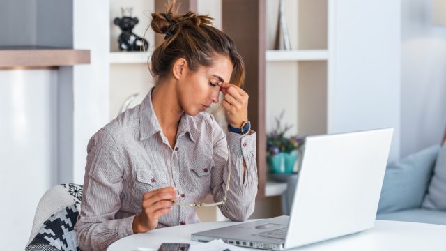 woman with tension headache sitting at desk