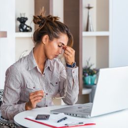 woman with tension headache sitting at desk