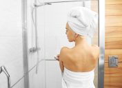 young woman stepping into shower