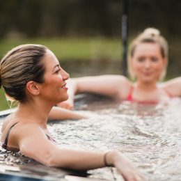 two blonde women using hot tub