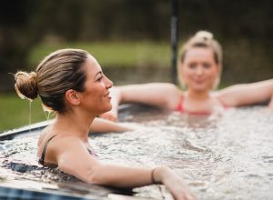 two blonde women using hot tub