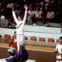 Nadia Comăneci on the medal podium at the 1976 Olympics