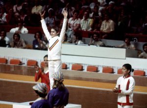 Nadia Comăneci on the medal podium at the 1976 Olympics